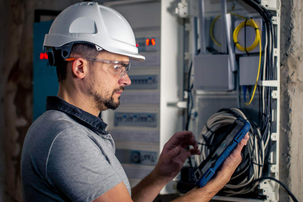 electrical technician working with tablet